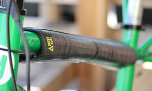 bicycle top tube protector made of repurposed materials by green guru shown on a green bike eco