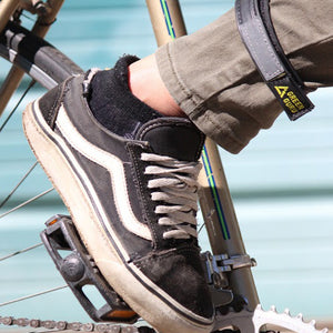 ankle strap for bicycling to keep pants out of chain lifestyle shot in use made from repurposed bike tubes green guru